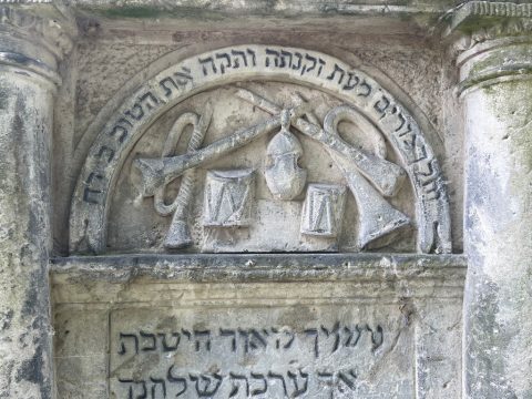 Musical instruments carved on a gravestone in the Okopowan Jewish cemetery